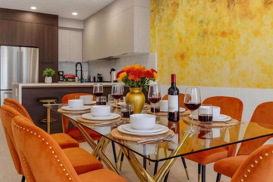 ELEGANT DINING ROOM! Sophisticated space with orange velvet chairs, and high chair for families. Perfect for special meals and celebrations. Book your upscale family stay today! #TopPhillyAIrbnb #FamilyFriendlyPhillyAirbnb