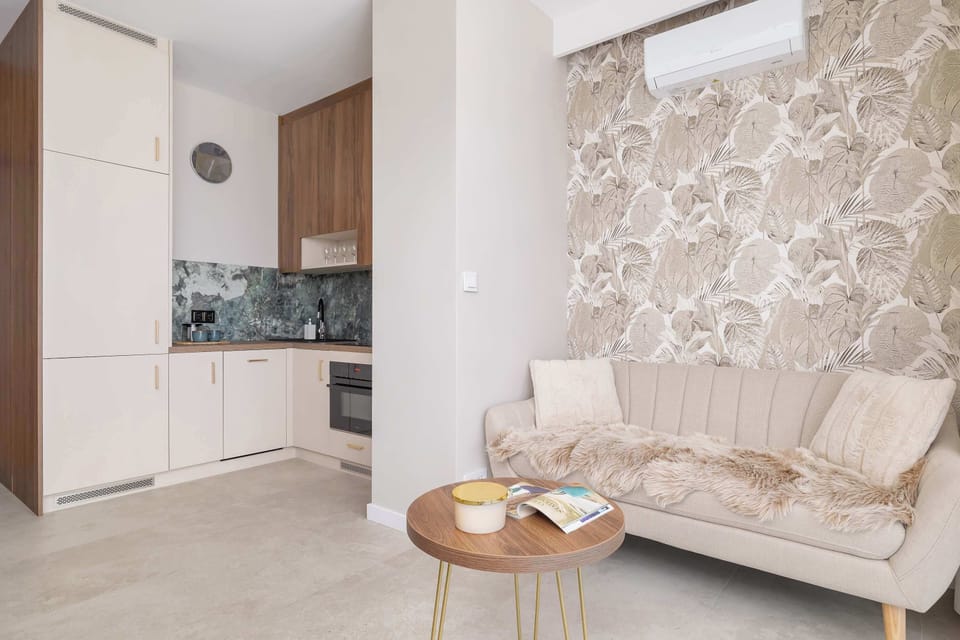A bright living room with a cozy sofa and soft natural light — perfect for relaxing or watching TV.