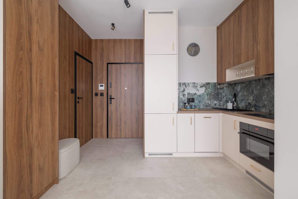 A functional kitchenette with appliances and natural light. Ideal for short or long stays