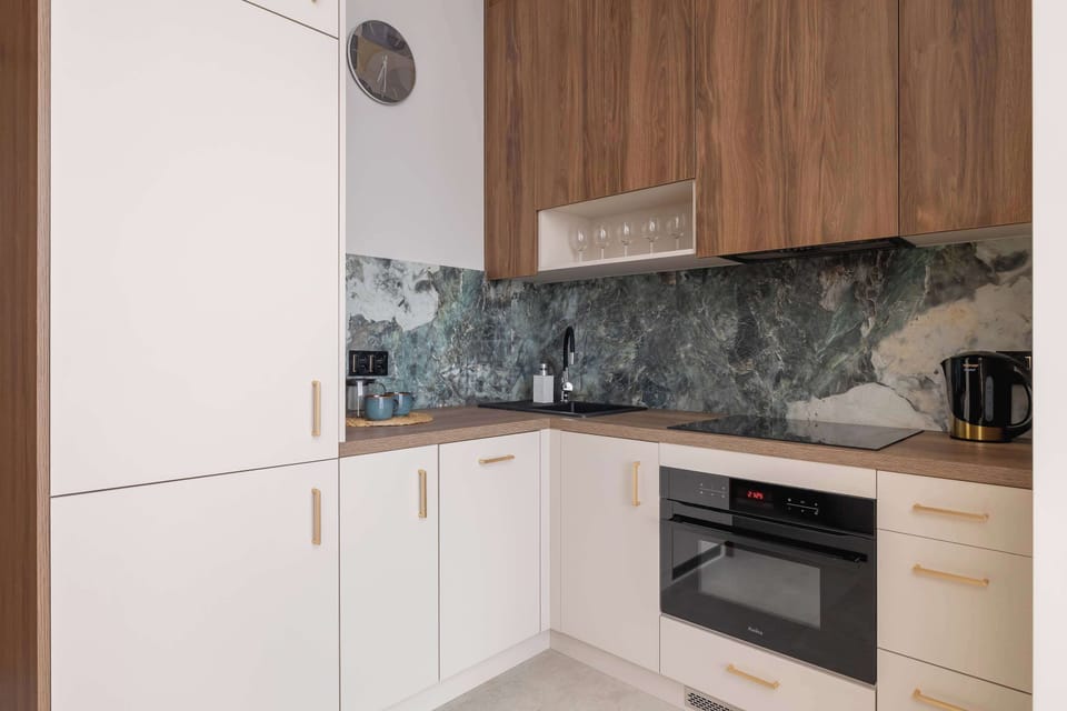 A neat cooking area with a modern oven and stylish finishes. Perfect for preparing simple meals.