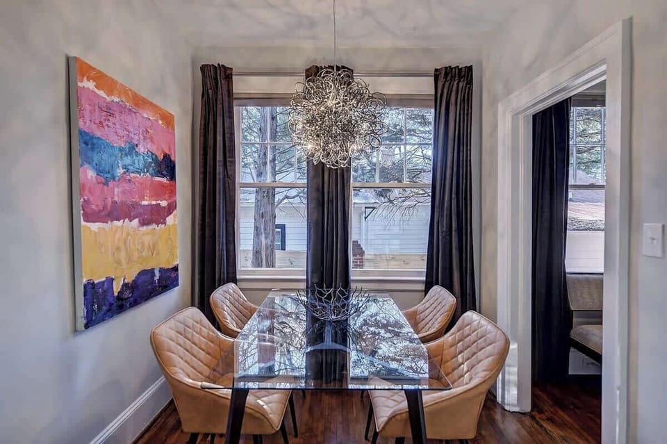 Mid-century modern chairs and a sparkling chandelier create a sophisticated atmosphere for any meal.