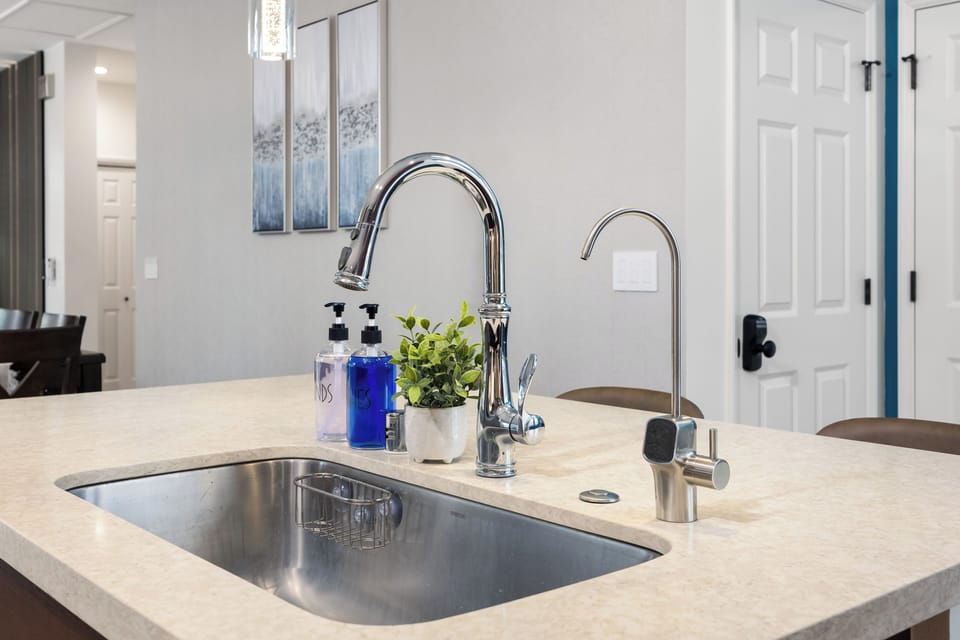 Modern kitchen sink setup with clean counters and thoughtful details!
