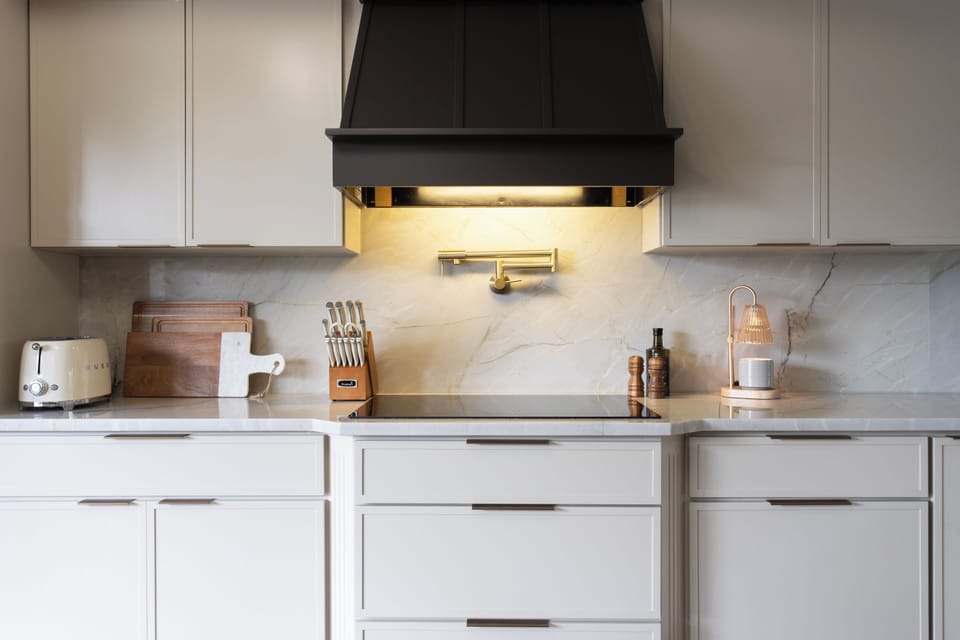 VIP vibes are built into every detail—reverse osmosis water filtration, pot filler, SMEG + NINJA appliances, and Caraway non-toxic cookware for elevated at-home meals.