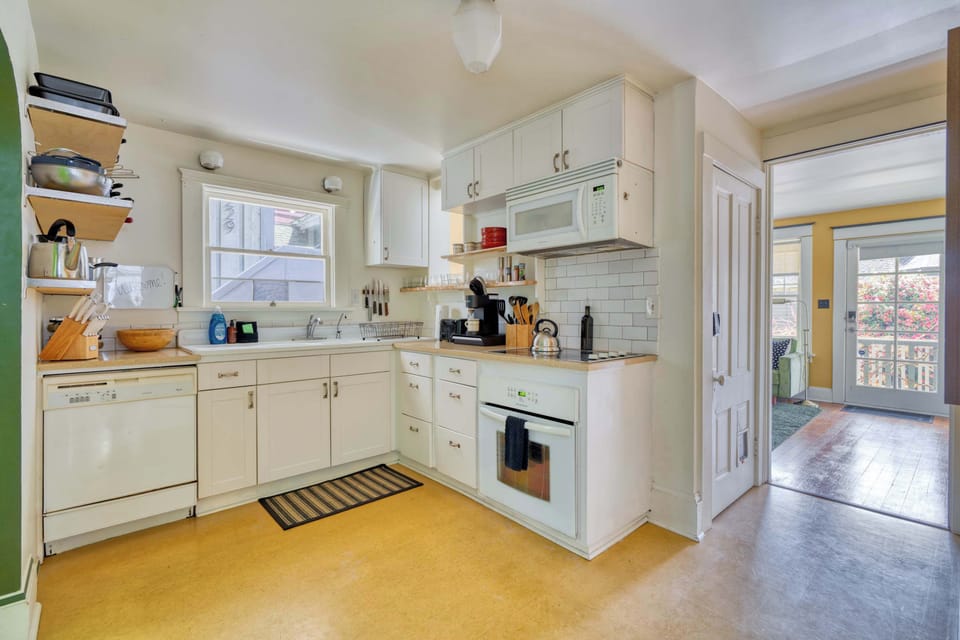Kitchen with range and white cabinetry.