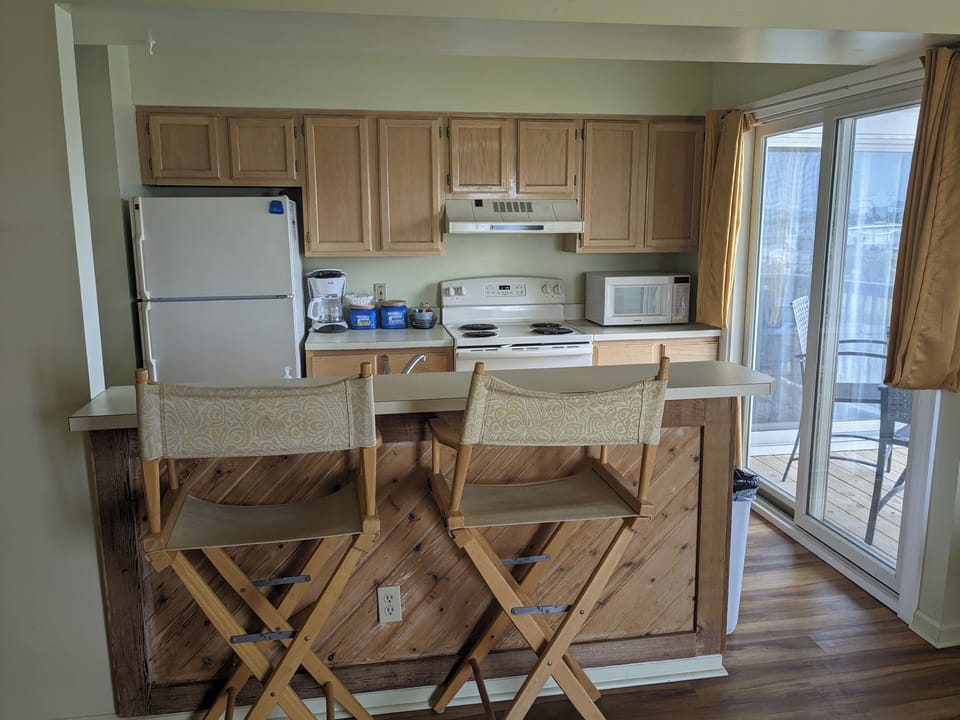 Kitchen with balcony with table and chairs