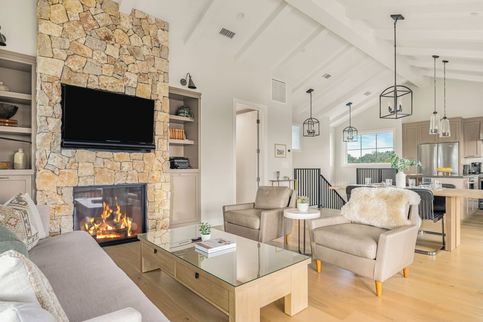 The living room features a fireplace, TV and ample seating. (Main house)