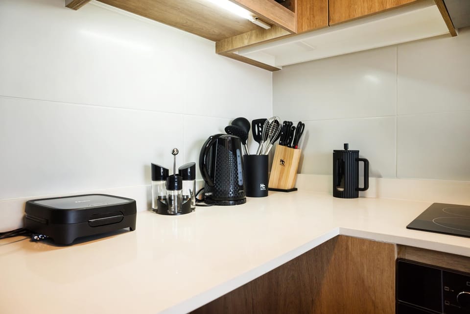 Well-equipped kitchen with modern appliances and ample counter space, perfect for preparing meals.