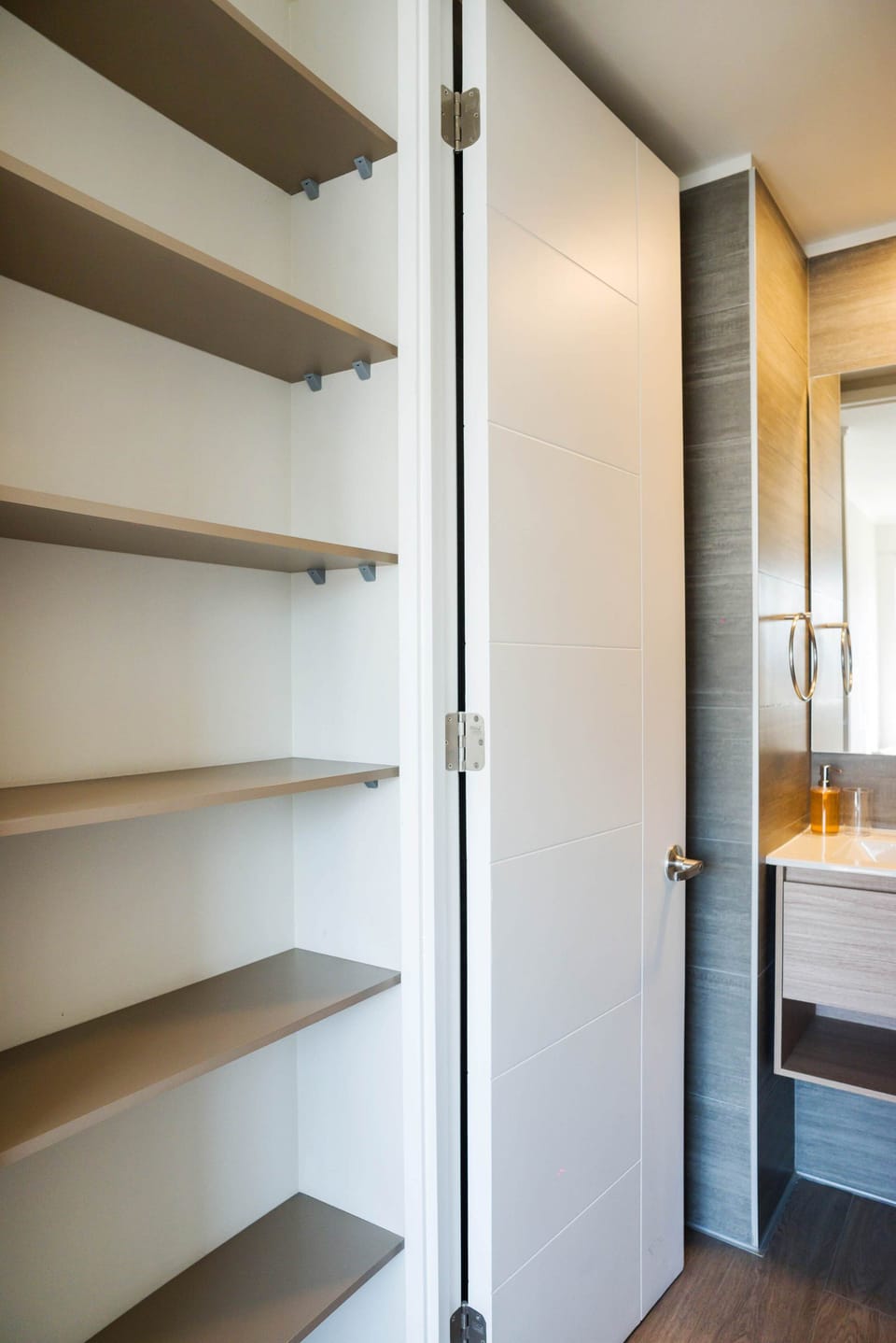 Modern bathroom with sleek design and ample shelving for your convenience.