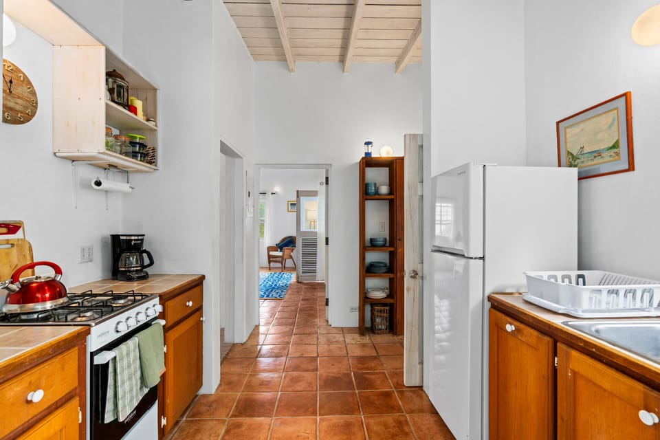 Makere Cottage kitchen with master bedroom straight ahead.