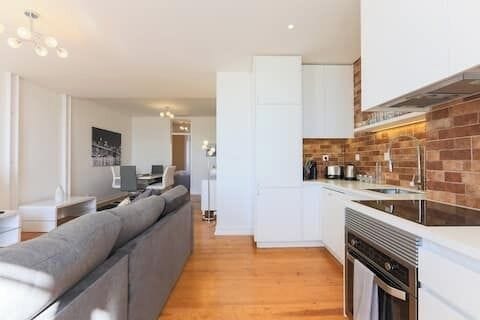 Open-plan living and dining space overlooking Lisbon • StayInLisbon
