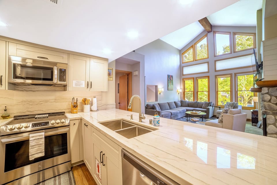 Newly renovated kitchen w/ solid stone countertops.