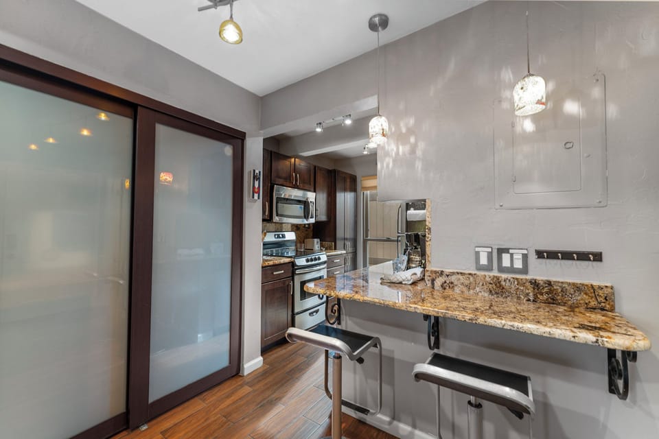 Your gourmet kitchen features granite countertops, stainless steel appliances, and elegant pendant lighting for memorable culinary experiences.