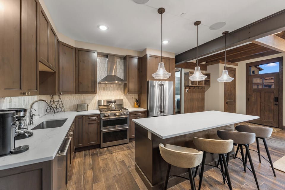 Your gourmet kitchen features rich wood cabinetry, marble countertops, and a spacious island perfect for gathering with family and friends.