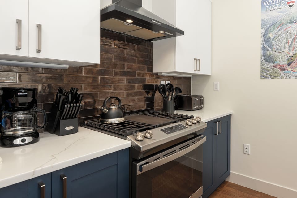 Your modern kitchen features premium appliances, stylish brick backsplash, and everything needed to prepare memorable meals during your stay.