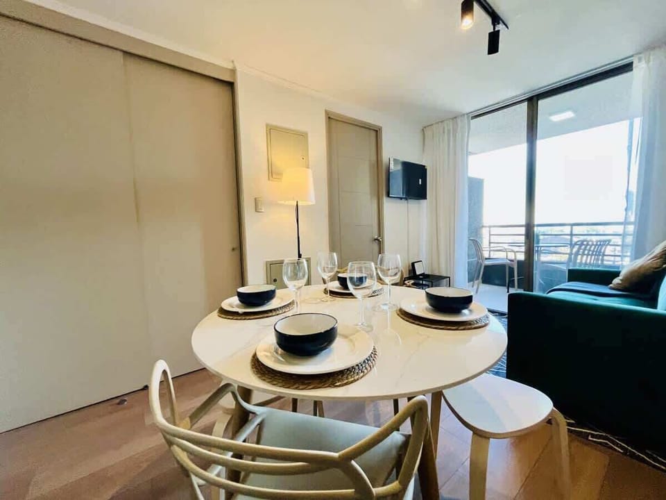 Dining nook w/ stylish table setting beside bright windows