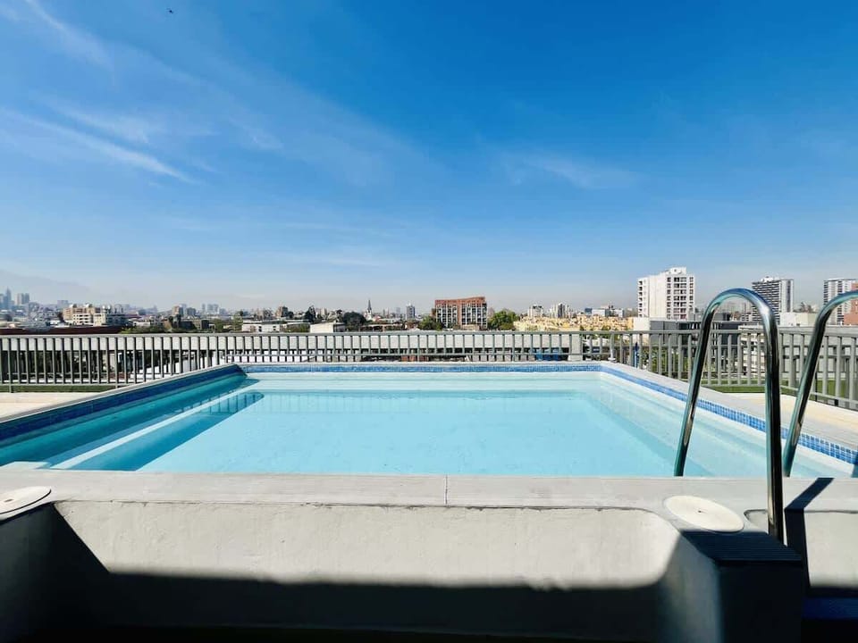 Refreshing rooftop pool w/ open skyline views, perfect for a sunny afternoon dip