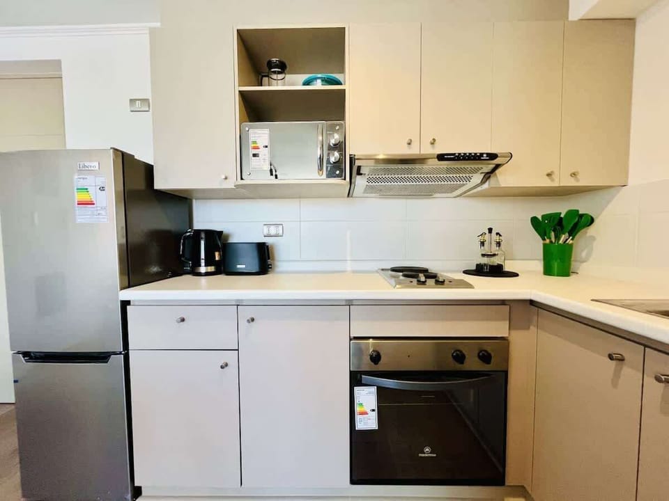 Compact kitchen w/ ample cabinets & stainless appliances