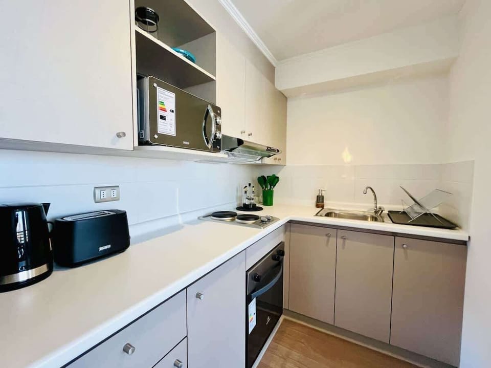 Functional kitchen w/ microwave, sink & generous counter space