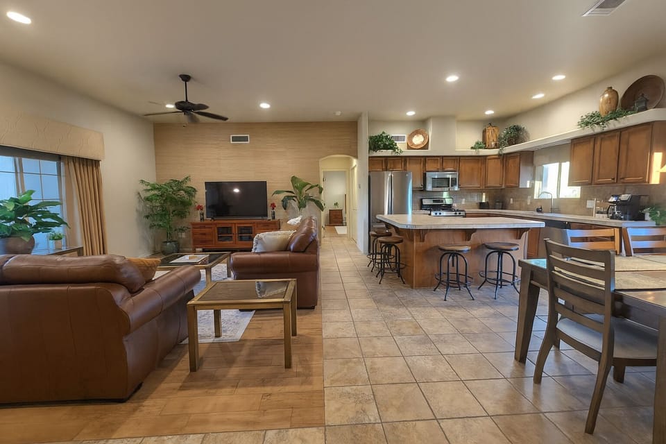 Comfortable living space - real leather couches and a 65-inch smart TV.