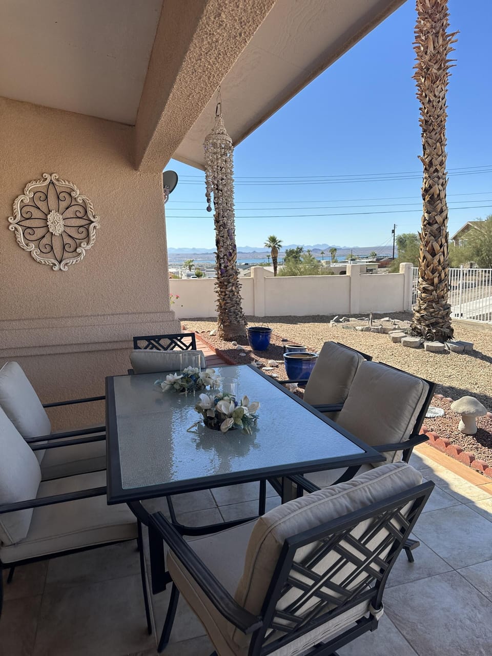 Shaded patio dining with serene desert views and palm trees
