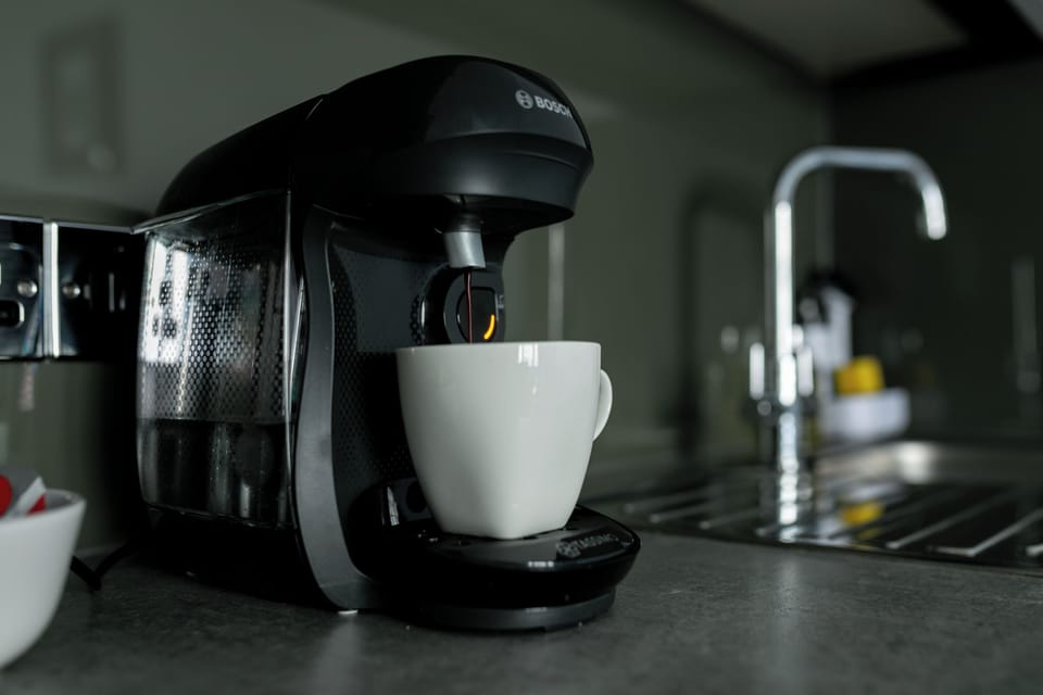 Close-up of coffee machine brewing a cup
