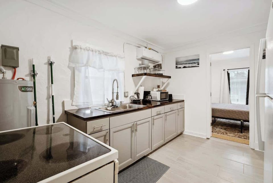 Modern kitchen w/ sleek counters, ample cabinetry & stainless appliances