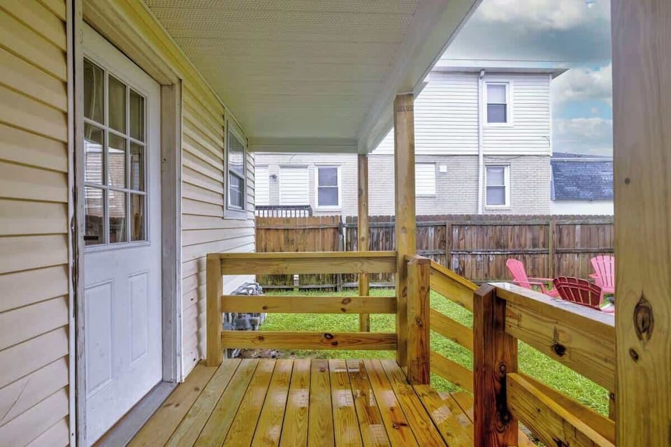 Covered wooden porch offering a quiet place to sit and unwind. Enjoy your morning coffee or watch the sunset from here.