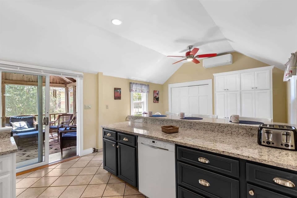 Enjoy effortless access from the kitchen to the screened-in porch  perfect for dining al fresco