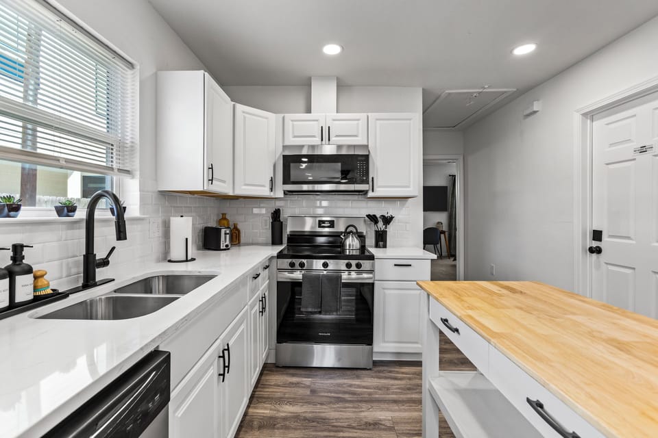 Double sink, coffee maker, and all the essentials you need to cook at home.