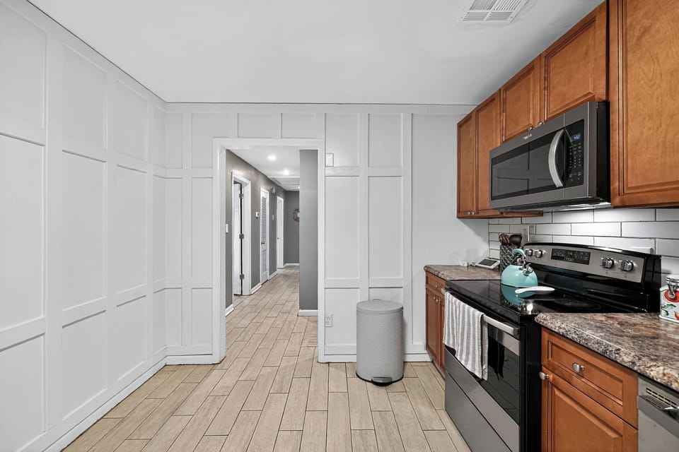 Well-equipped kitchen with oven, stovetop, and microwave for home cooking