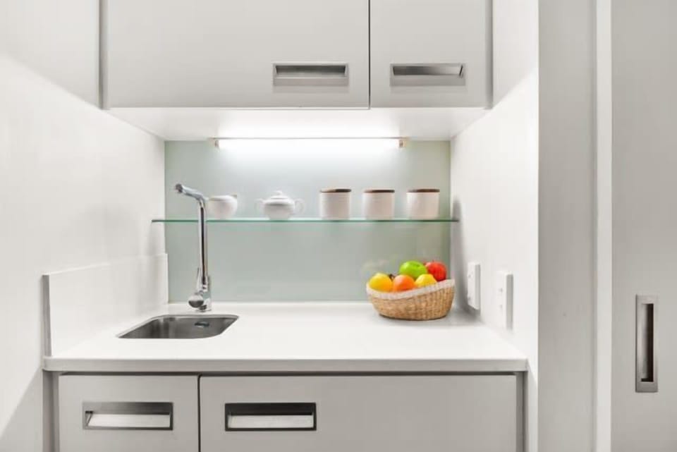 Compact kitchenette with a clean, modern setup for light meals and refreshments.