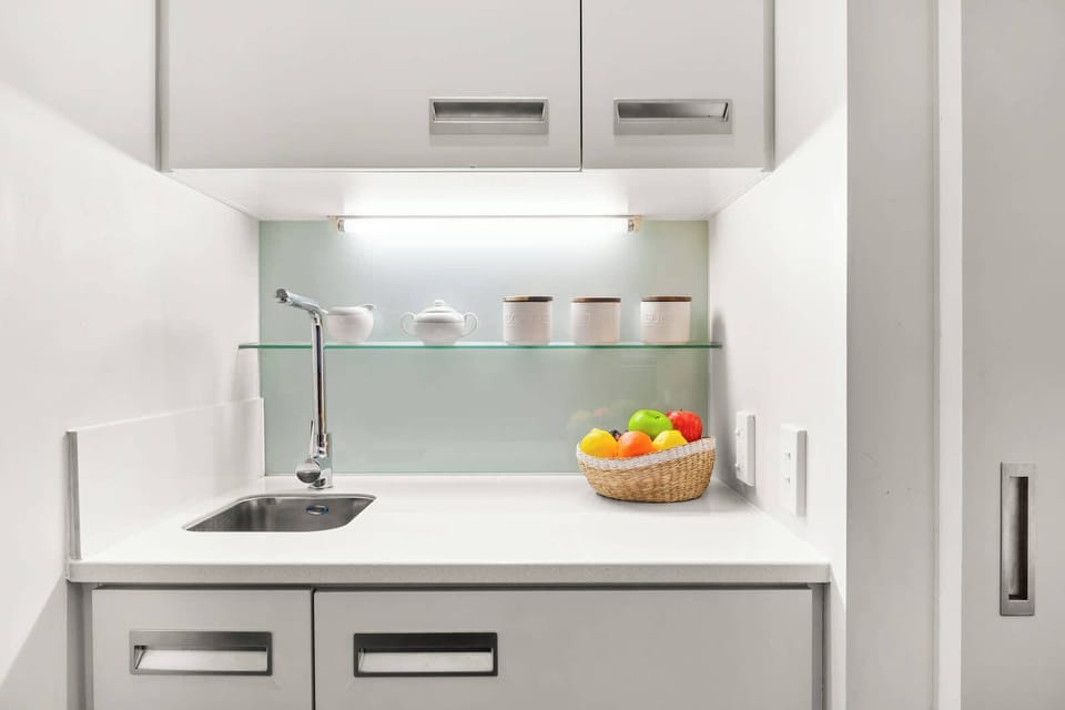 Compact kitchenette with a clean, modern setup for light meals and refreshments.