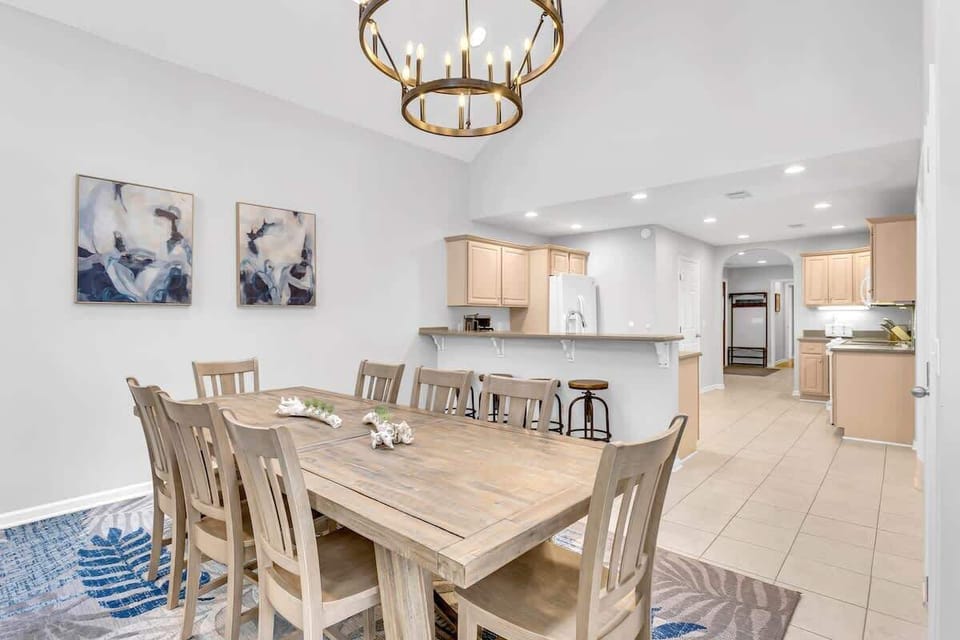 Gather around your spacious dining table where golden light and open kitchen flow create the perfect setting for memorable meals together.