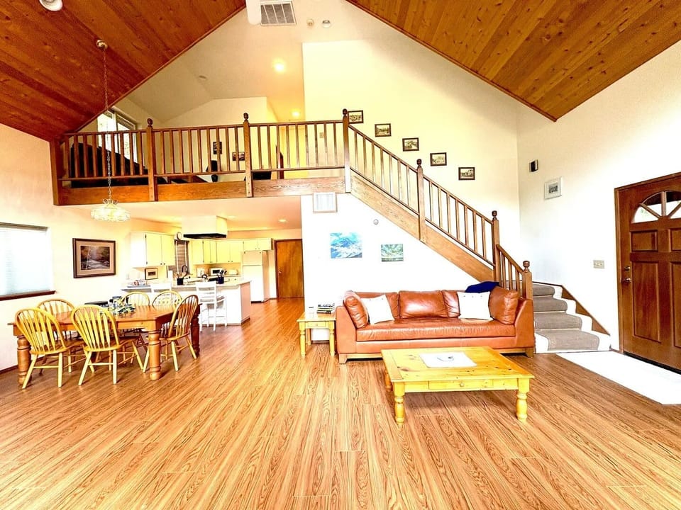 Living room with stairs to the sleeping loft and 2 more bedrooms