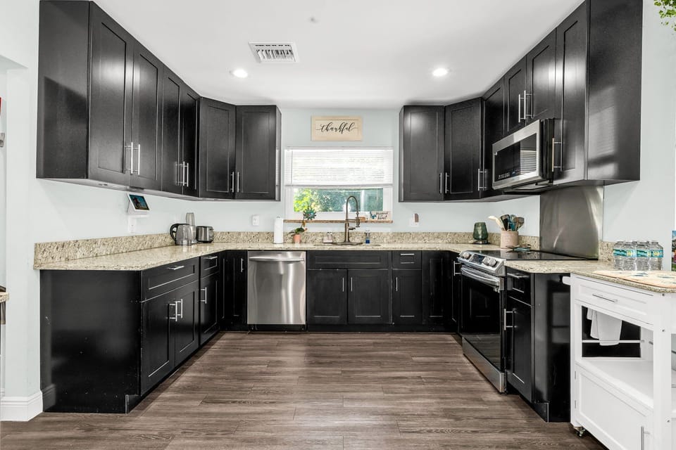 Sleek modern fully equipped kitchen with stainless steel appliances and plenty of counter space, perfect for cooking and with everything you need for a comfortable stay