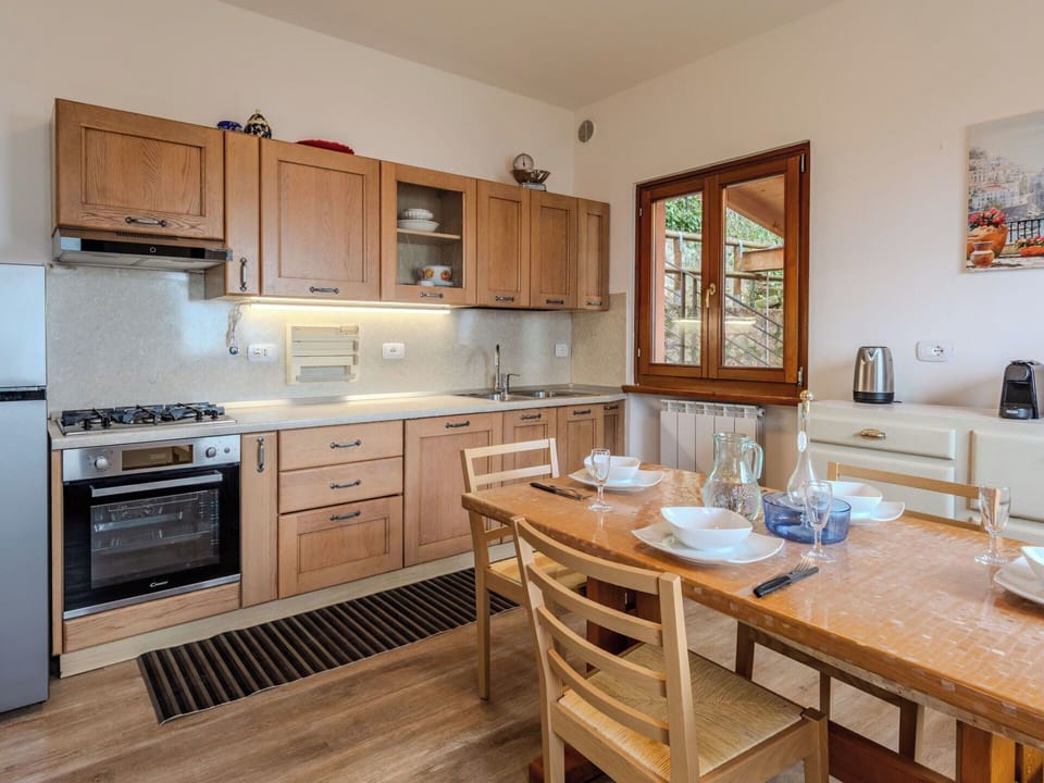 Furniture, Kitchen, Cabinetry, Countertop, Kitchen Appliance, Interior Design, Flooring, Wood, Major Appliance, Cupboard