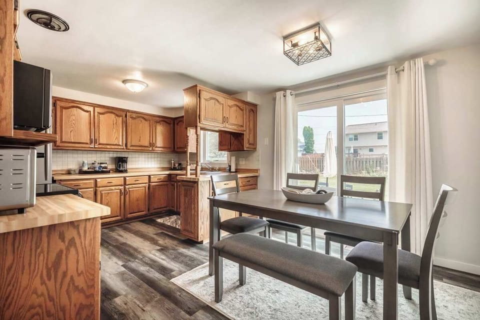 Bright dining area and kitchen featuring a table for meals and sliders that open to the patio—perfect for indoor-outdoor living and entertaining.