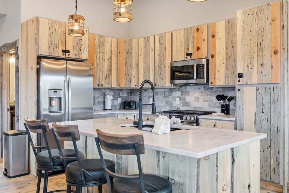 Your rustic dream kitchen awaits with reclaimed wood cabinets, modern appliances, and a welcoming island perfect for morning coffee and evening conversations.