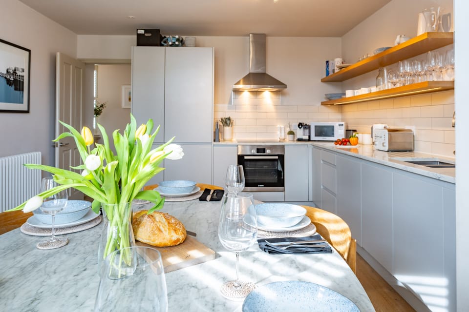 First floor: Kitchen/ diner with an electric oven and induction hob, large fridge/freezer, microwave, dishwasher, washing machine, tumble dryer and coffee machine