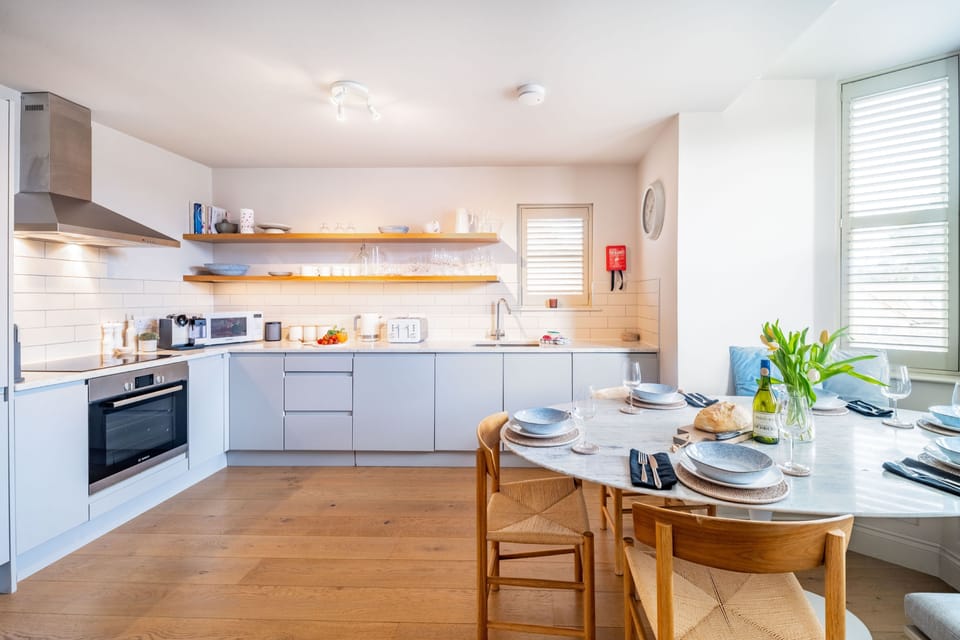 White Horses (2), Blakeney: Kitchen/ diner with an electric oven and induction hob, large fridge/freezer, microwave, dishwasher, washing machine, tumble dryer and coffee machine
