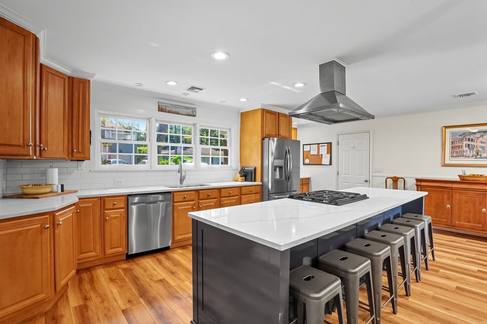 Full Kitchen with Island Seating – 4326 12th Street - A bright, open kitchen with stainless appliances, gas range, and seating for five at the island—perfect for breakfast before a beach walk or happy hour prep after.