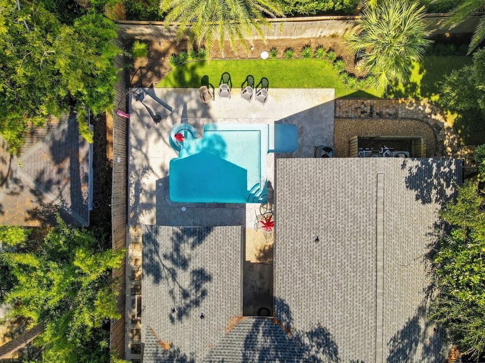Aerial View of Private Pool - Bird’s-eye view of the fenced backyard and private pool—complete with loungers, umbrellas, and total privacy in the heart of East Beach.