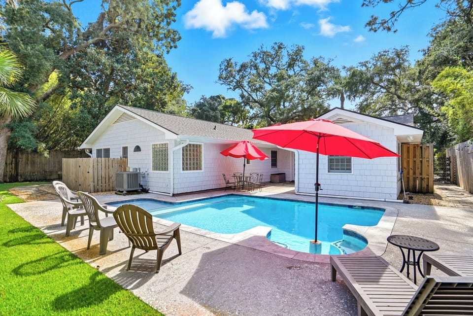 Heated Private Pool, Outdoor Shower – 4326 12th Street - Fully fenced backyard with a private pool, lounge chairs, and outdoor shower. Optional pool heat keeps swim days going year-round—just minutes from East Beach access.