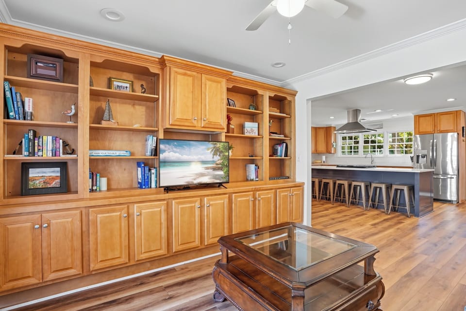 Den with Built-In Shelving - Inviting den with custom built-ins, smart TV, and open flow into the kitchen—perfect for a quiet read, movie night, or catching the game while dinner’s cooking.