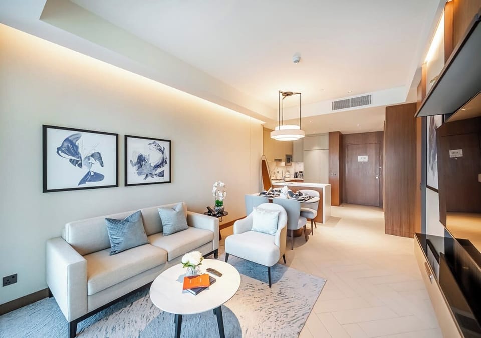 Elegant living room with stylish seating, chic décor, and ambient lighting.