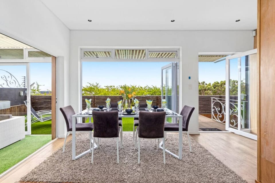 Stylish modern dining table for six, complemented by abundant natural light.