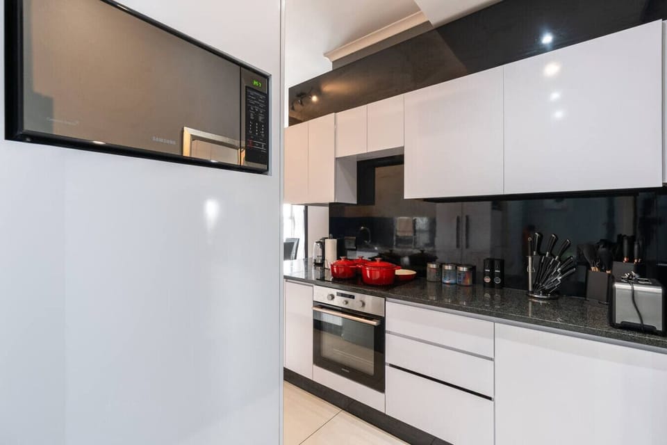 Modern Kitchen: Unleash your inner chef in a sleek, modern kitchen equipped with chef-ready appliances and vibrant accents, creating an inspiring and stylish space for cooking and gatherings.