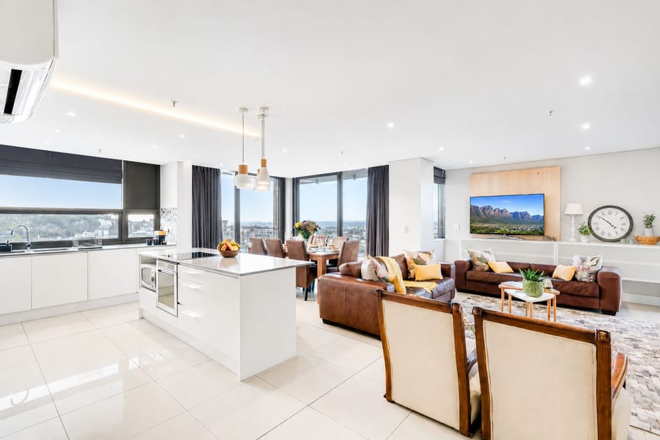 Open-plan kitchen, dining, and lounge with sweeping city views

