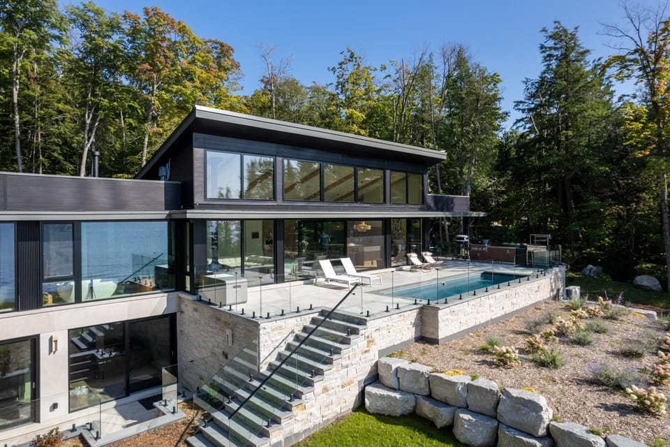 Sleek modern patio with infinity pool and forest views