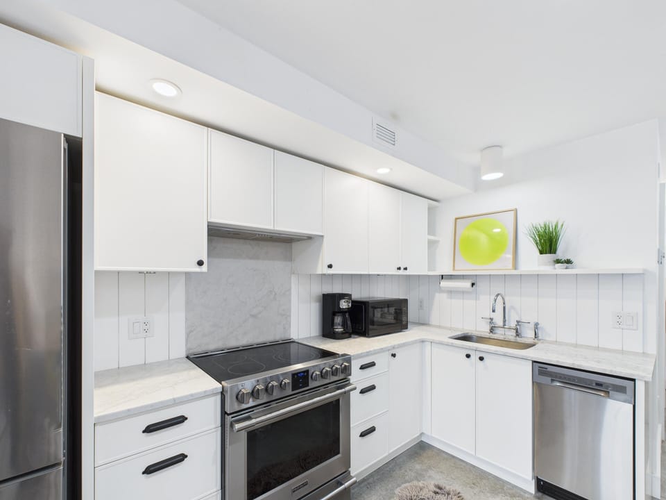 Modern kitchen with sleek appliances and ample storage, for your cooking needs!